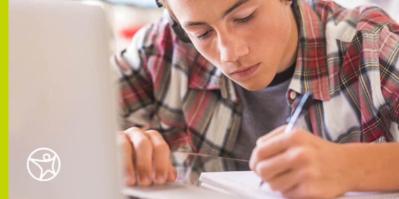 Student writing in a Journal