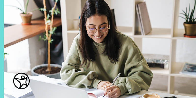 Student smiling while working on a homework assignment