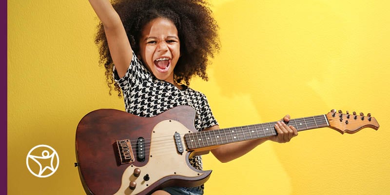 Young girl playing an electric guitar