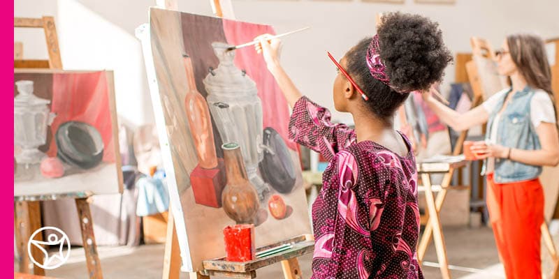 A student painting on a canvas