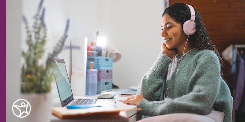 Teen student working on school at laptop