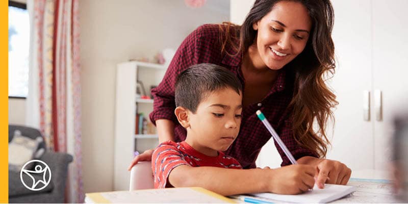 A mother is helping her son with online school classwork