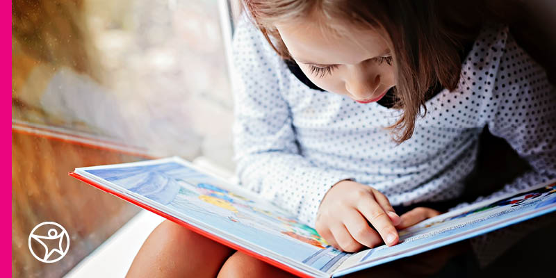 A young girl reading a book