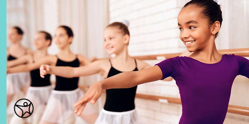 A smiling elementary school student on his laptop