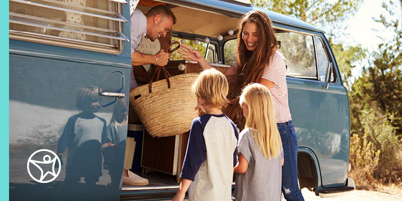 A family loading a van with summer items for fun activites with their children.