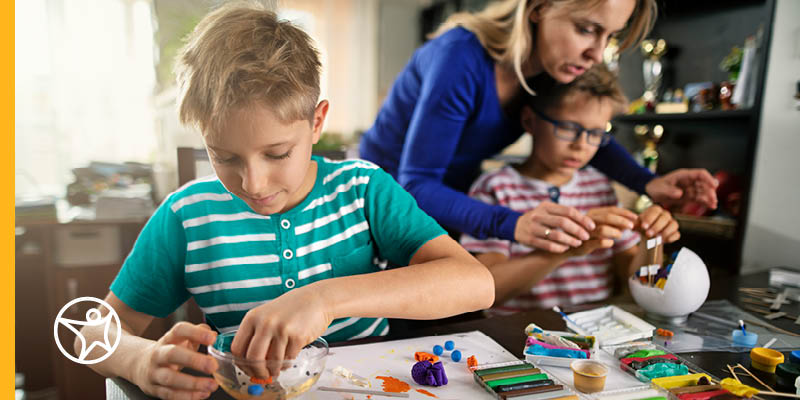 Student sitting at a table working on a STEM project for online school