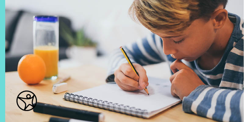 Student completing work for online project based learning while sitting at a table