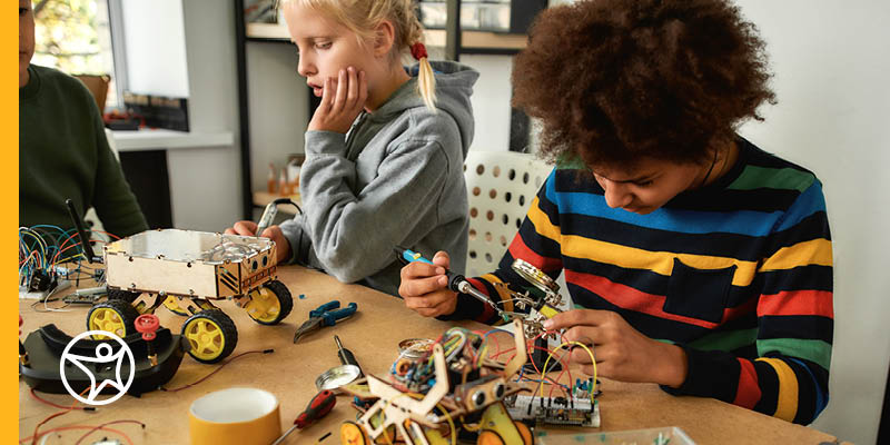 Two students building a robot for a STEM class