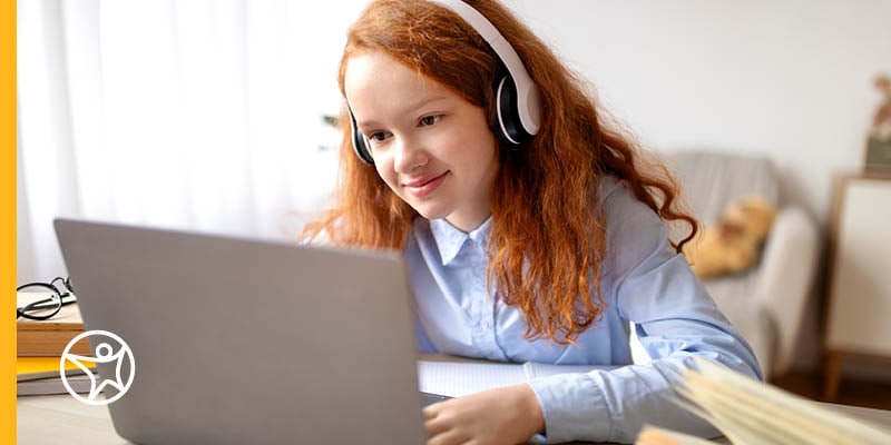 A student on her laptop engaging in a language immersion program