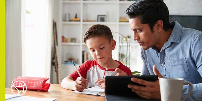A learning coach helping his son practice math