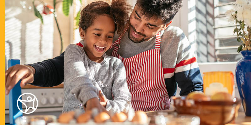 A parent and child prepping meals together for school.