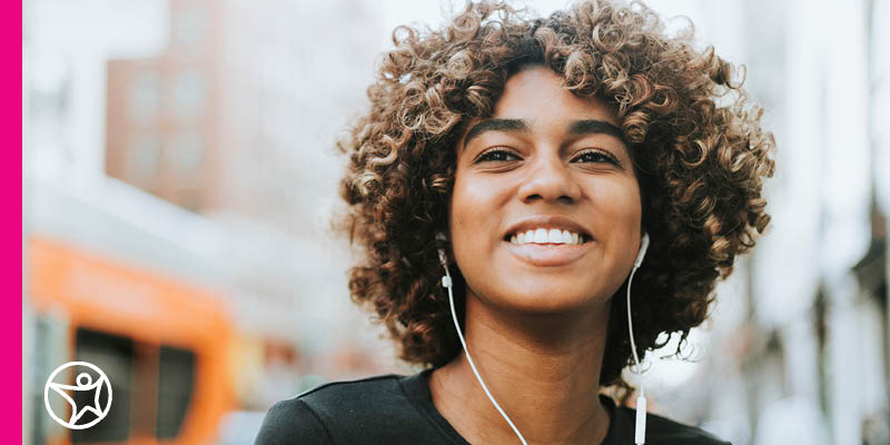 A student listens to an educational podcast through her headphones.