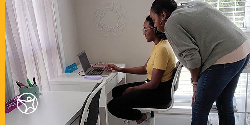 Ms. Daley, a Connections Academy parent is helping her daughter with an online school course