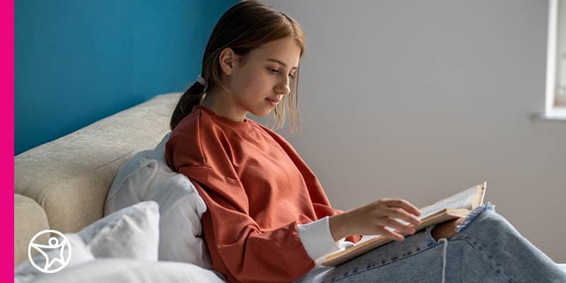 A high school student reading a poetry book