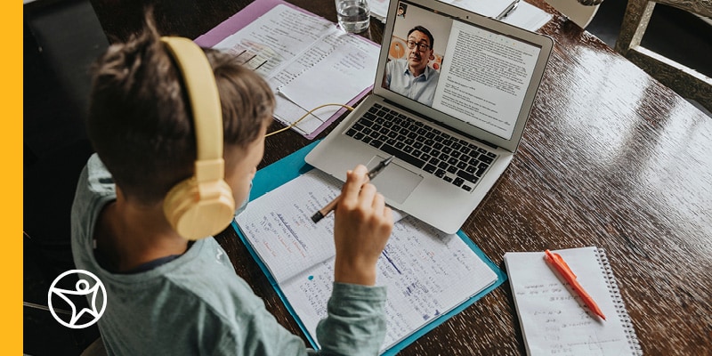 Boy participating in online school on his laptop