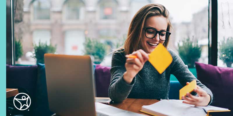 Time Management Personality Styles image - a woman using sticky notes to keep track of her tasks.