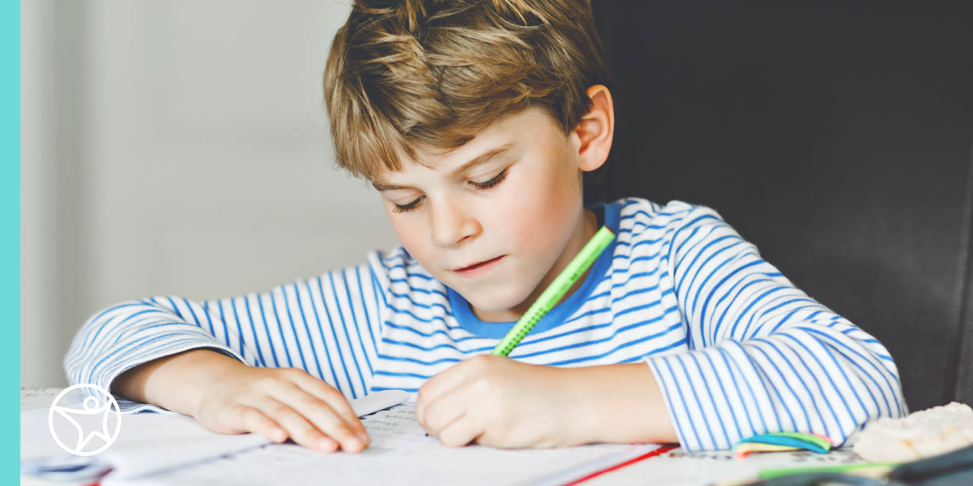 A young boy is doing his online school classwork