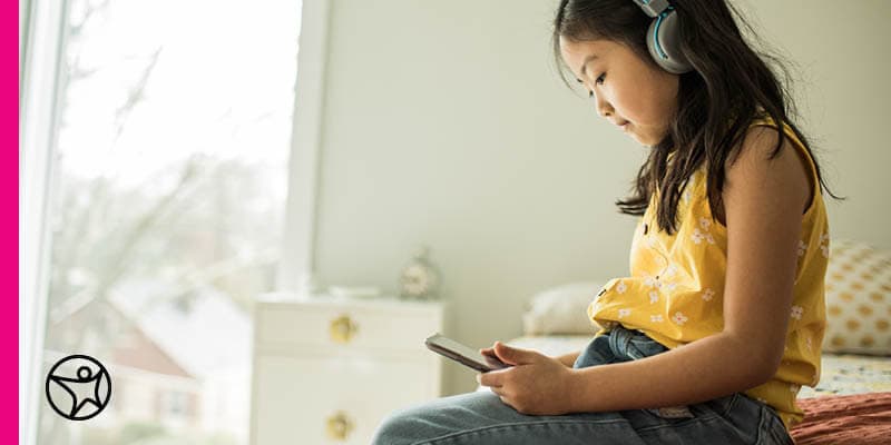 A middle school student is using her smartphone to browse the internet