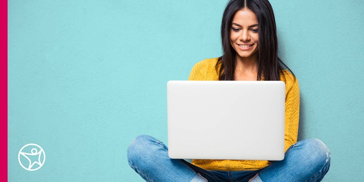 A high school student sitting with a laptop
