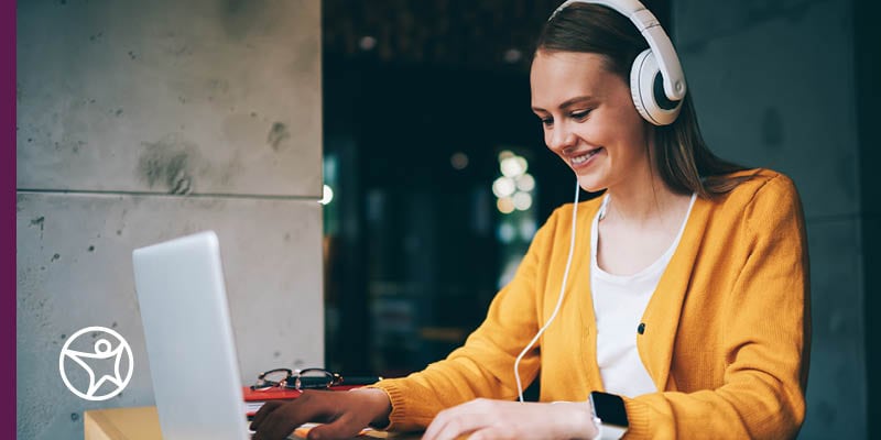 A teenage students is happily participating in an online class