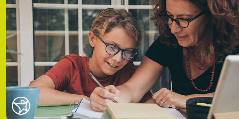 A student and learning coach going over a checklist.