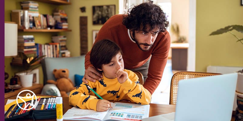 A Learning Coach and his child working together in their home classroom.