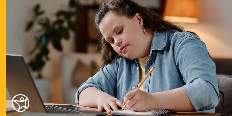 Student writing thank you note to their teacher