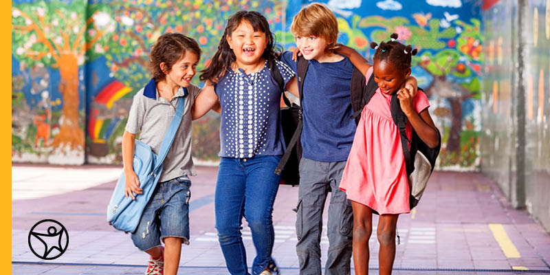 A group of children walking happily down the street.