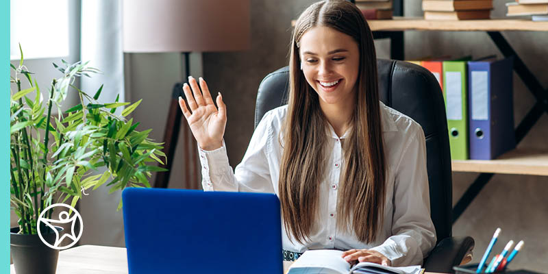 Image of a young female student in a white shirt taking an online test on her laptop.