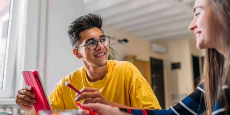 Two teenagers working on a class project