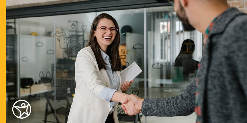 A student learning new skiils siting at a table with an adult