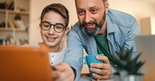 A parent serving as Learning Coach for his online student.  