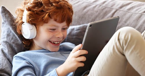 A child uses a tablet to do active learning activities for elementary school students. 