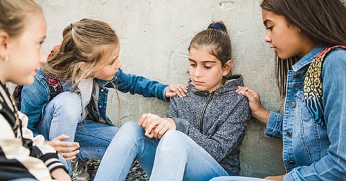 Students supporting a victim of childhood bullying