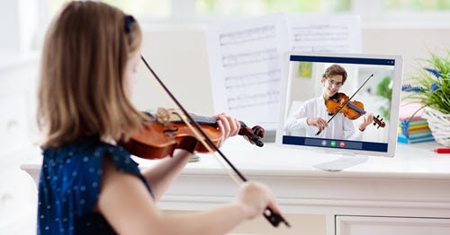 An online student taking a virtual music lesson.    