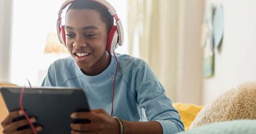 An online school student uses a tablet to romaticize reading and doing homework.