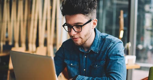 An online school student at a cafe forms an online study group to help romanticize studying and learning.