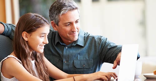 A parent and student using a computer to research tutors for middle school students. 