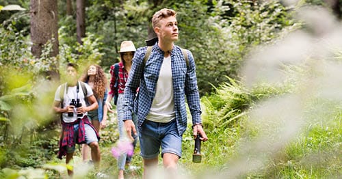 A group of students participate in screen free activities by going on a hike. 