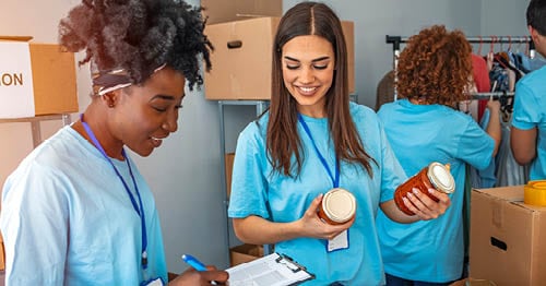 A group of online students sort through donations as they volunteer in their community.