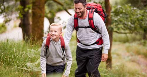 A parent and child go for a hike to decrease stress.