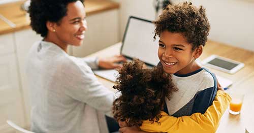 Two children show each other kindness on random acts of kindness day.