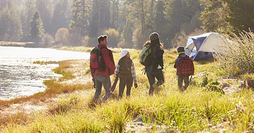 A family prioritizes mental health during the holidays by taking a walk in nature