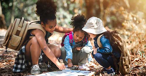 Students reading a map while on a hike. 