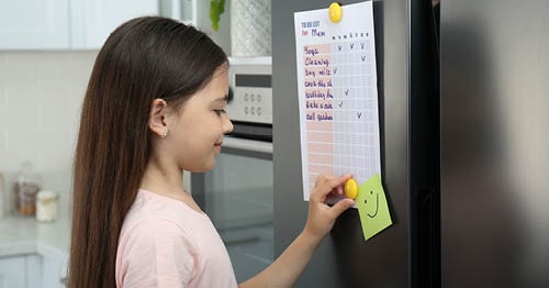 An online student checks her daily schedule to achieve her New Year's Resolutions.