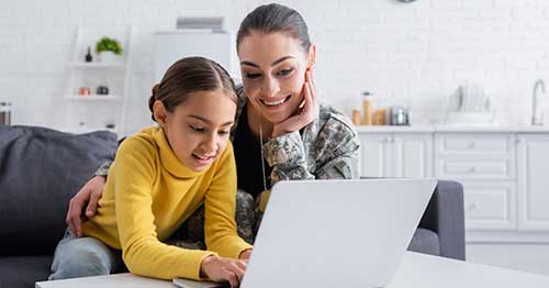 A mother and child exploring the benefits of online school for military families.