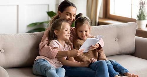 A parent reading with her children. 