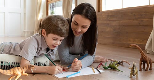 A parent and an online student working on an assignment to build good academic habits.