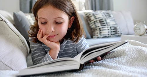 An online student doing some self-care for kids by reading.