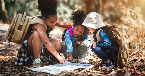Children on a hike out in nature as part of a naturalistic intelligence activity.